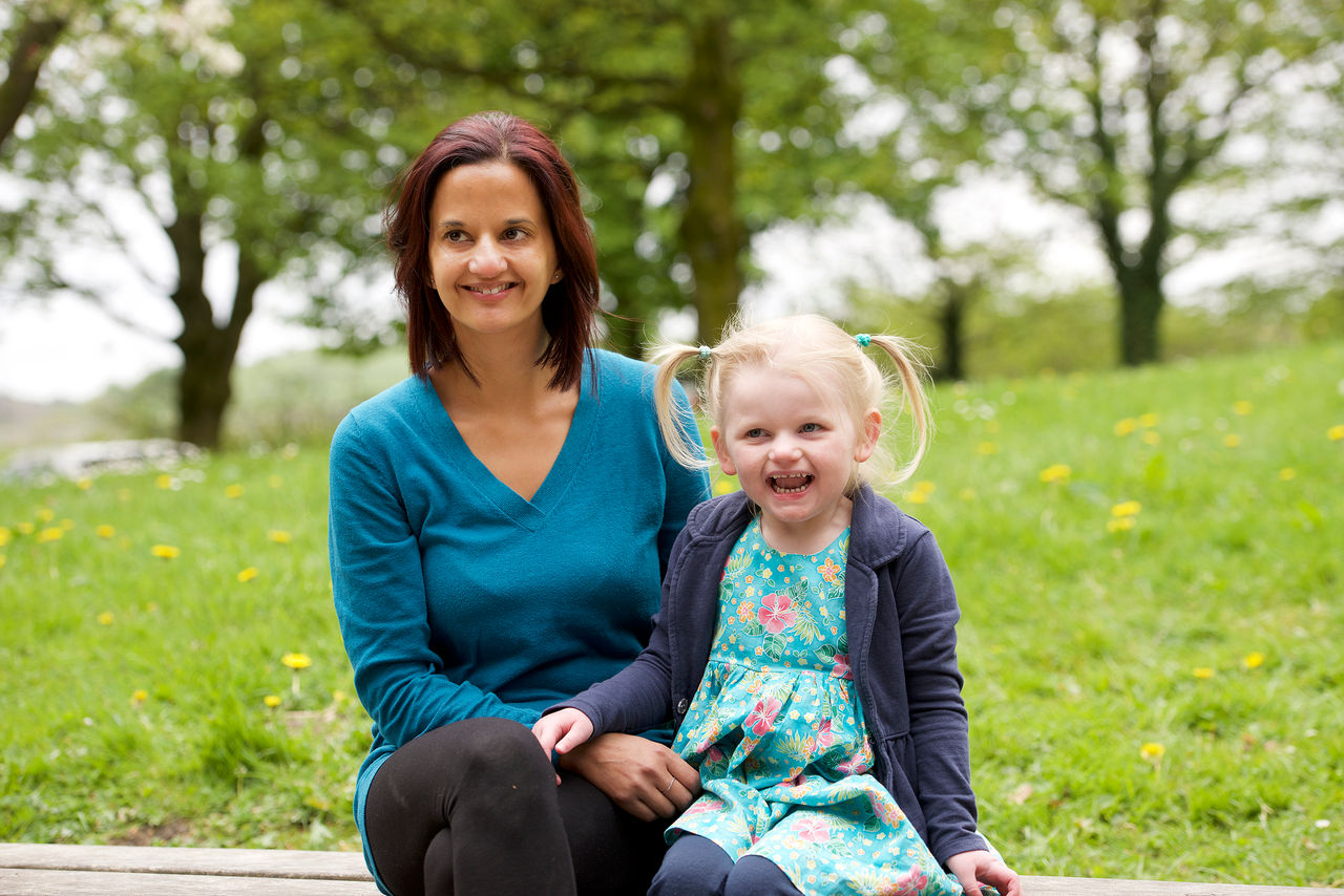 Mother and daughter sitting on a bench