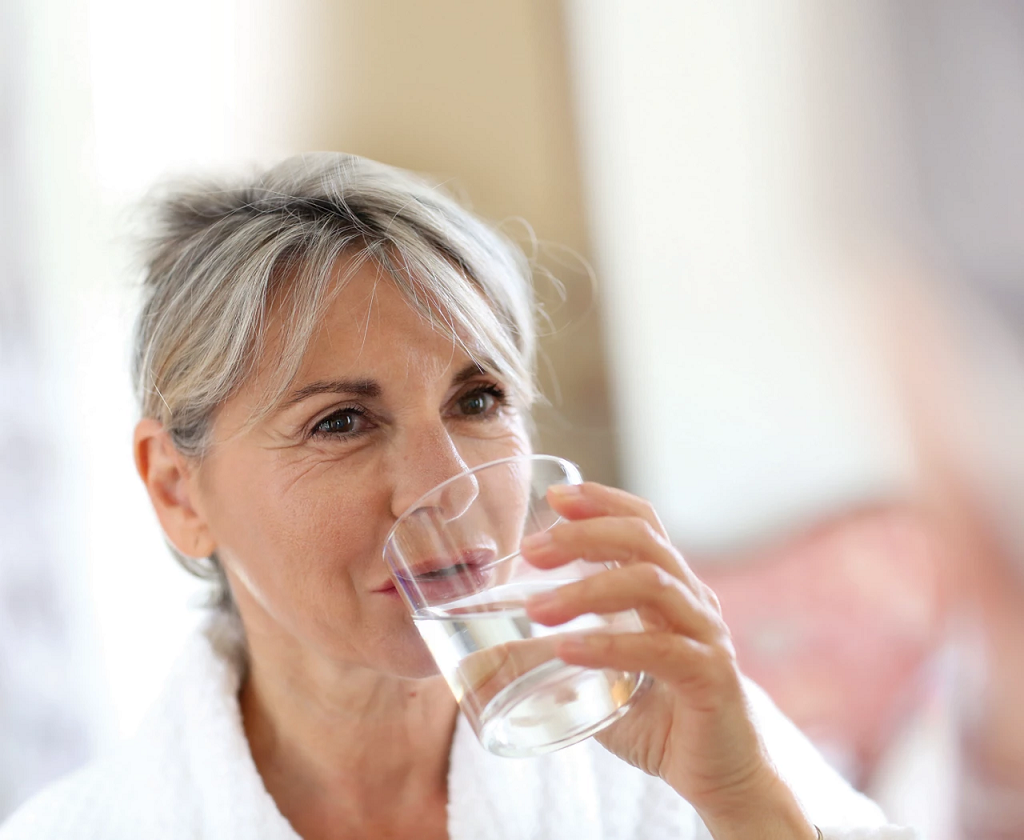 Senior woman drinking a glass of water