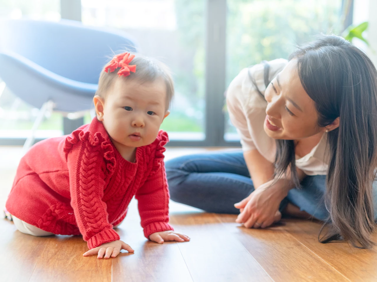 Mother playing with baby on the floor